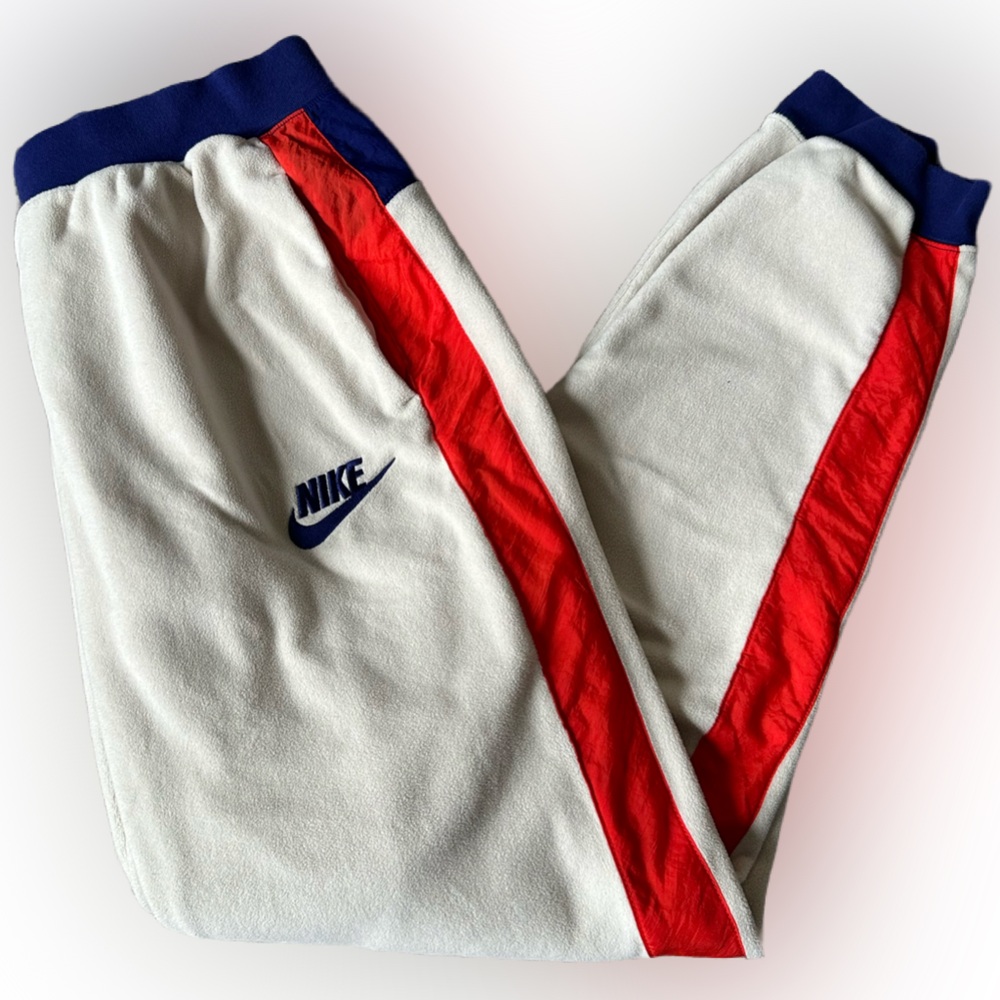 Women’s Meduim Nike Polar Fleece Cream with Red and Blue details.